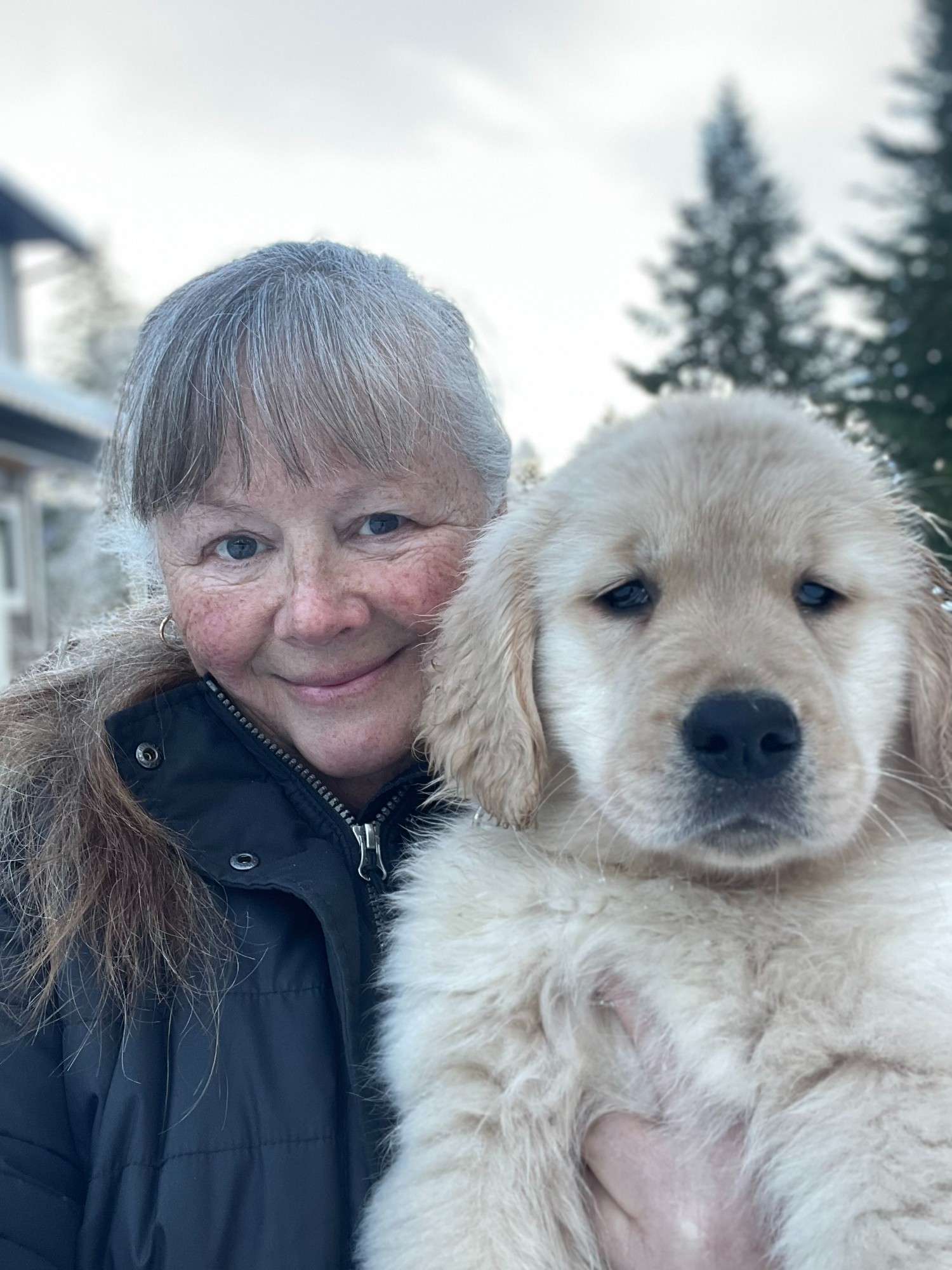 Christine holding a Golden Retriever puppy